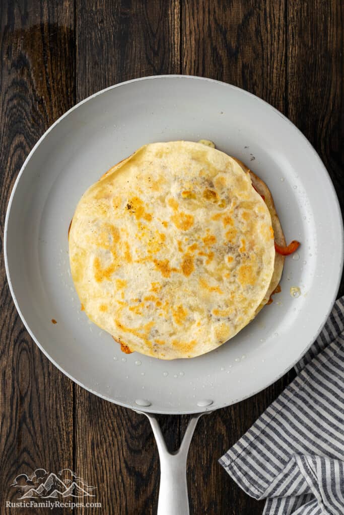 Cooked steak quesadilla in a skillet.