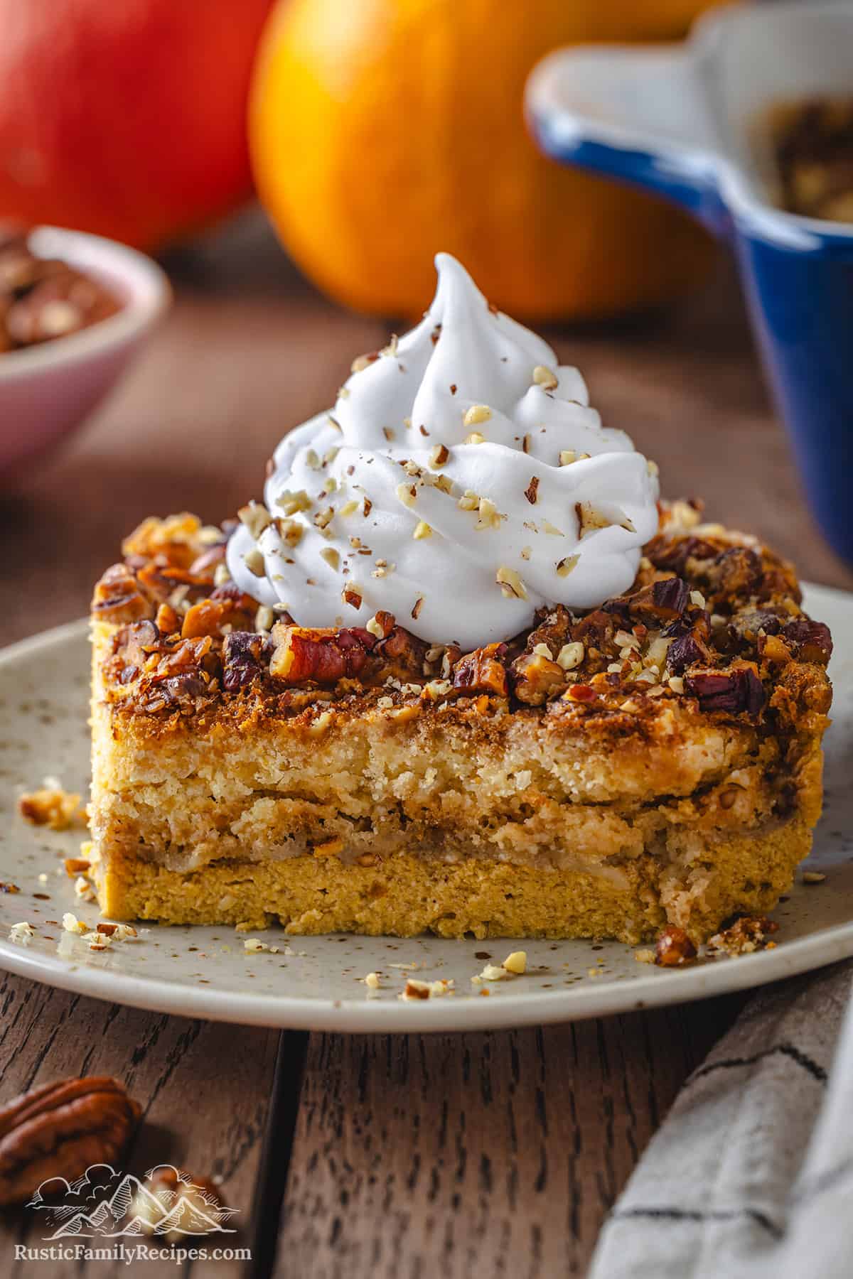 Slice of pumpkin crunch cake topped with whipped cream.