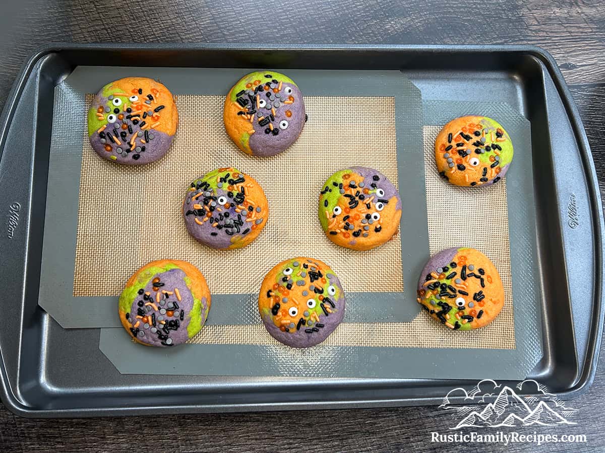 Baked Hocus Pocus cookies on a tray cooling.