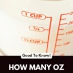 A measuring cup with milk in it an units of measurement on the side